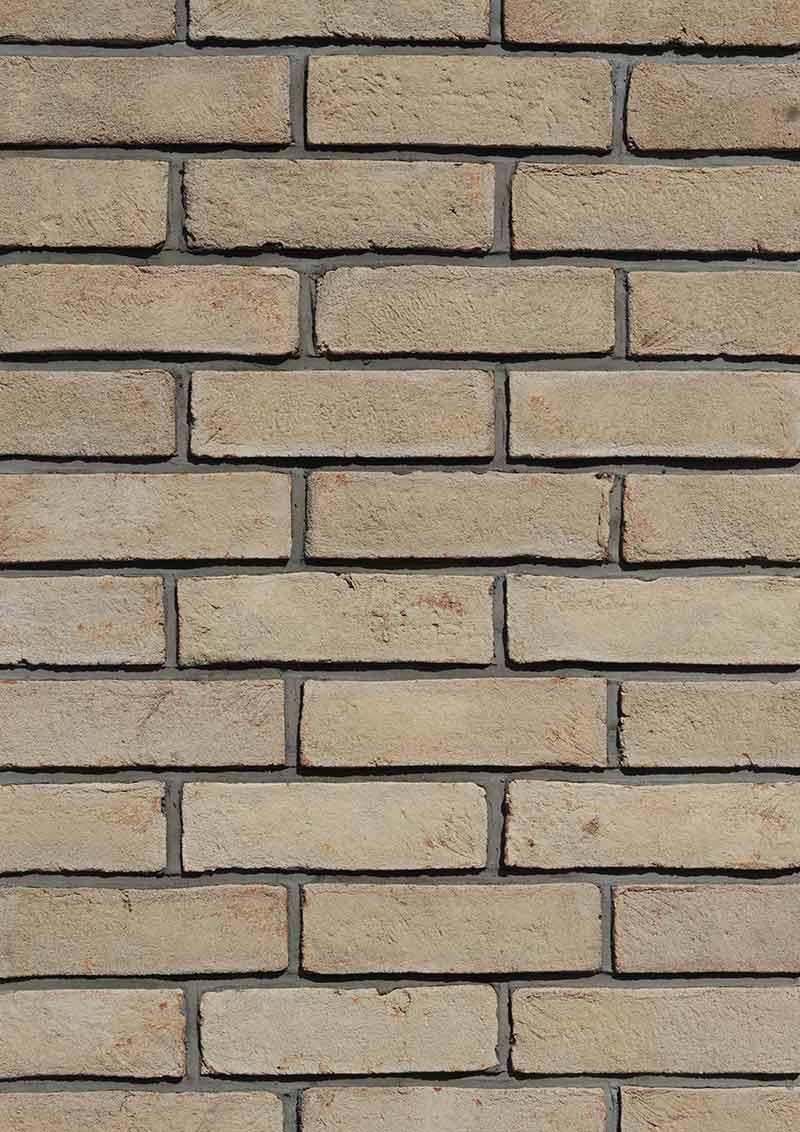 Modular Cream Thin Brick Veneer. Pale Ivory with Sandy-Hues. 1/2″ Thickness. Subtly Aged Surface with Distressed Corners.