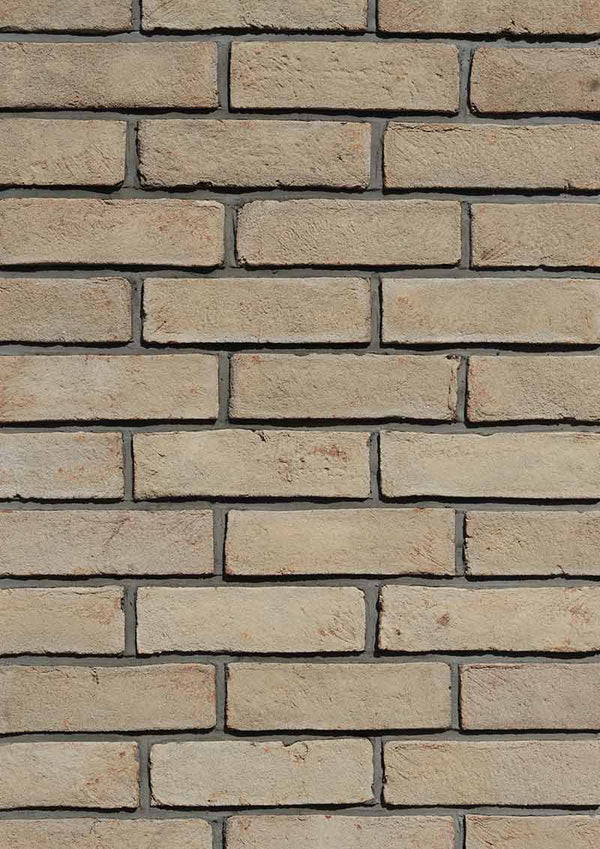 Modular Cream Thin Brick Veneer. Pale Ivory with Sandy-Hues. 1/2″ Thickness. Subtly Aged Surface with Distressed Corners.