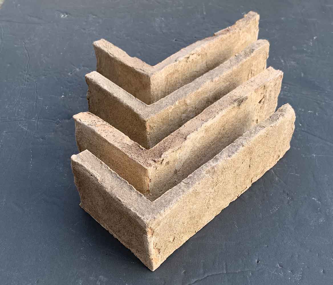 Modular Cream Thin Brick Veneer. Pale Ivory with Sandy-Hues. 1/2″ Thickness. Subtly Aged Surface with Distressed Corners.
