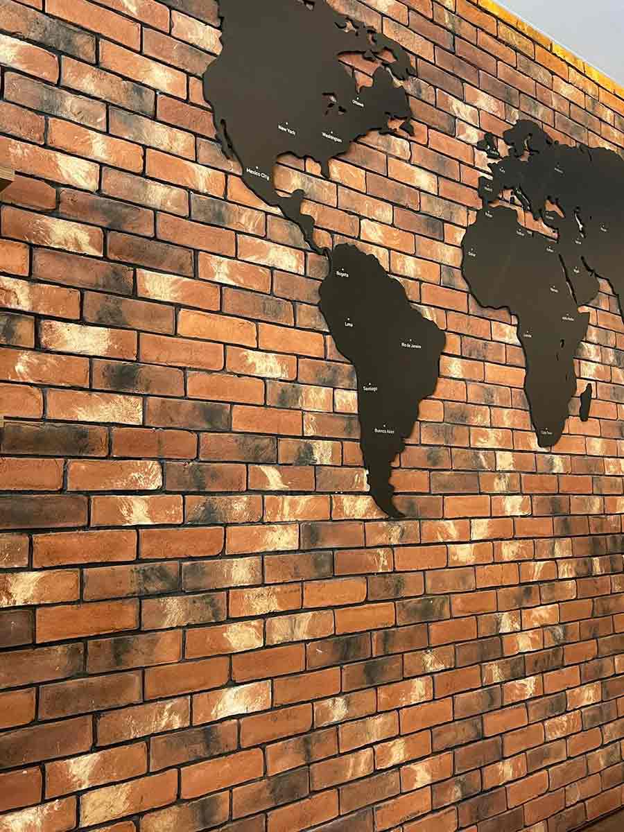"Reclamation" Modular Thin Brick Veneer. Multi colored. Red Background with Charcoal Accents and Subtle White Highlights. 1/2″ in Thickness.
