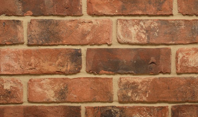 Modular Stained Thin Brick Veneer. Weathered Patina with Deep Terracotta tones &amp; black and white shades on the surface. 1/2″ in Thickness.